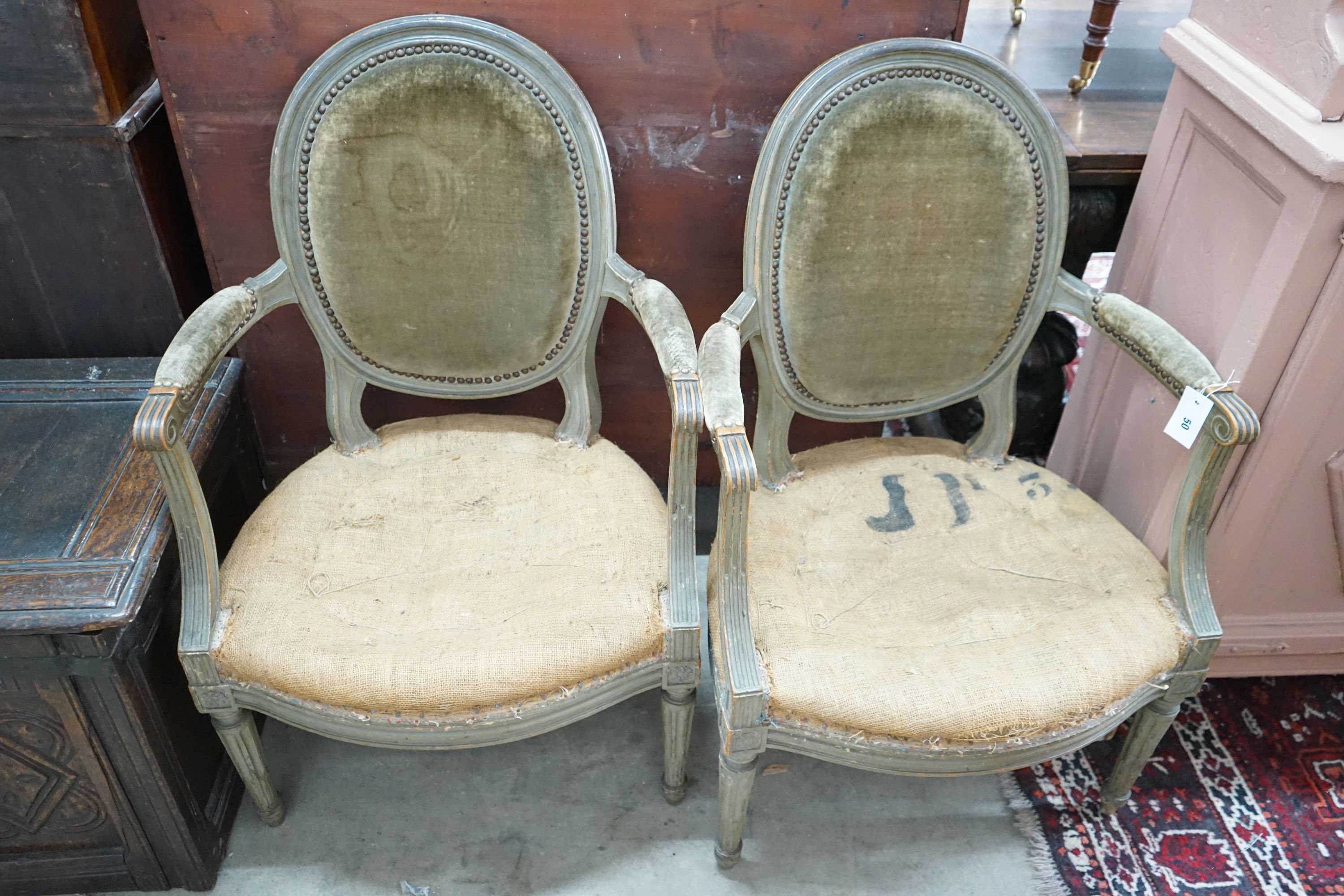 A pair of Louis XVI style painted fauteuils, width 59cm, depth 50cm, height 92cm